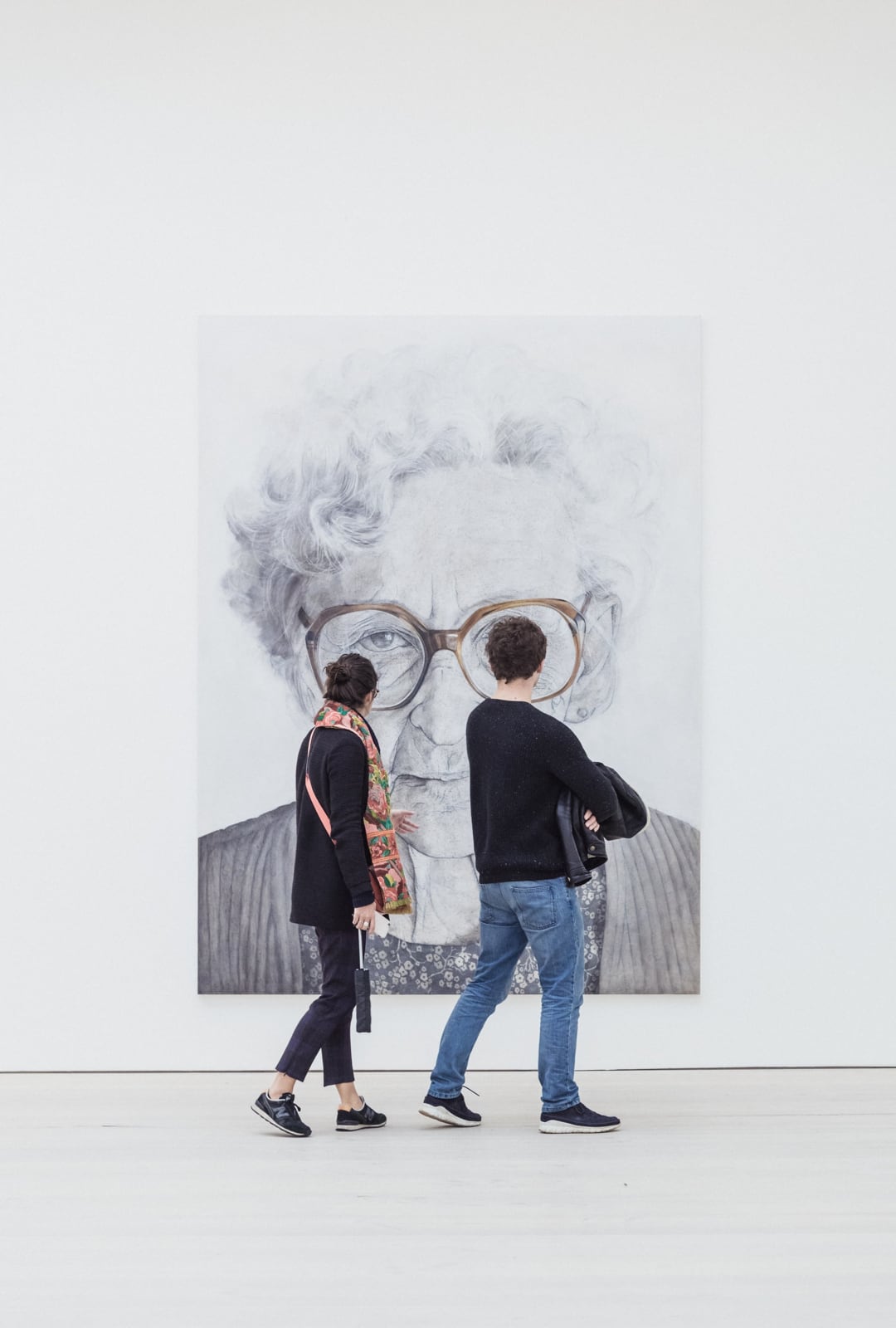 Two people looking at art